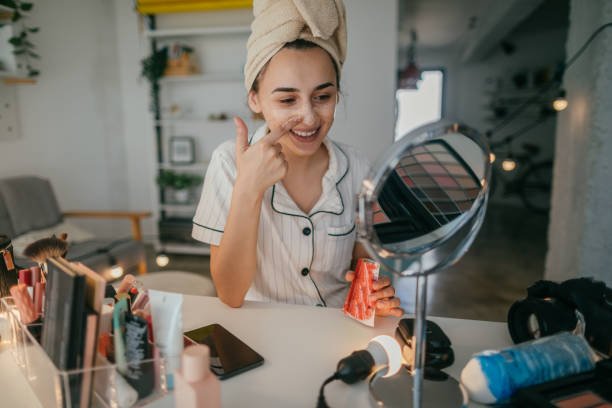 young woman in her apartment doing her beauty care routine
